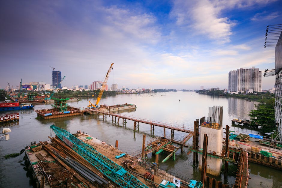 A vibrant city waterfront scene featuring a construction site and skyline.